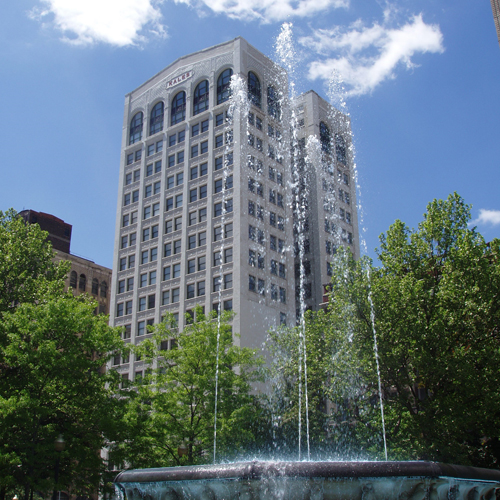 Kales building high-rise with fountain in foreground