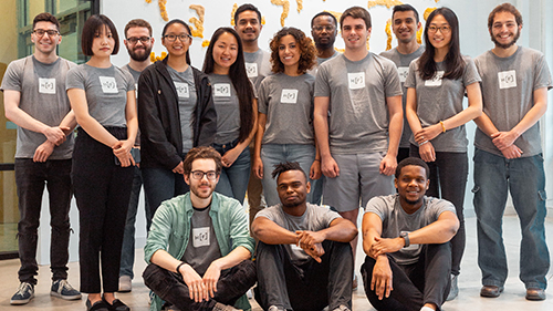 Young adults smiling at camera in gray t-shirts