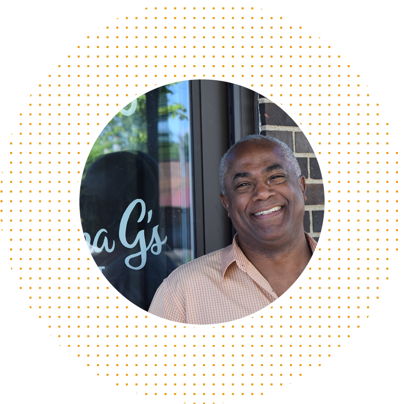 Man smiling in front of business