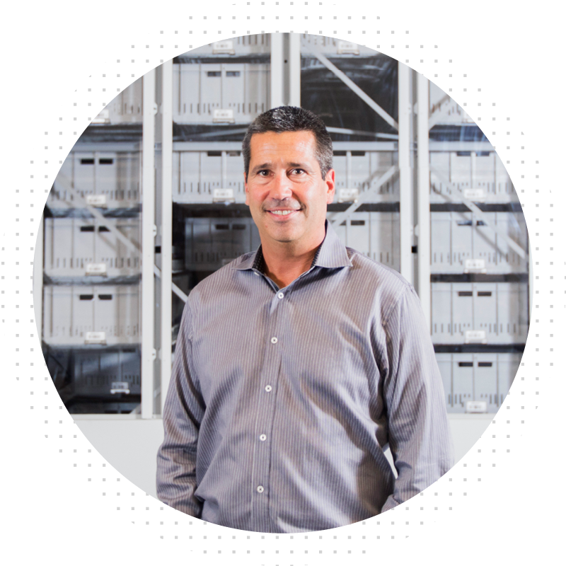 Man smiling at camera from warehouse
