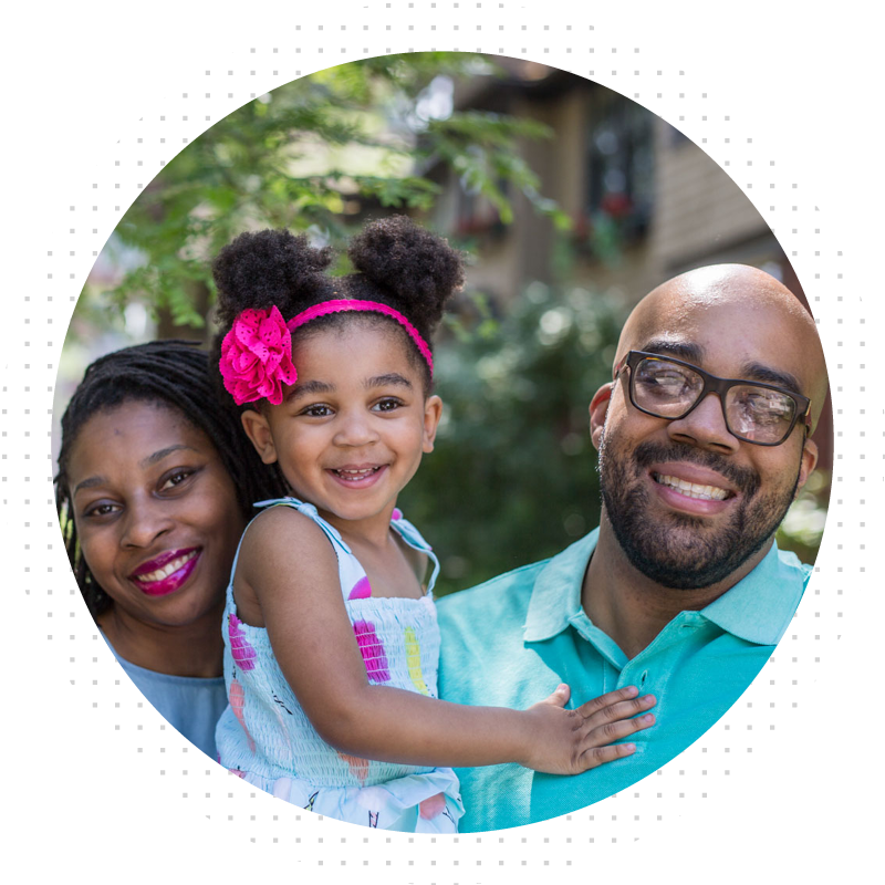 Man, woman, and daughter smiling at camera