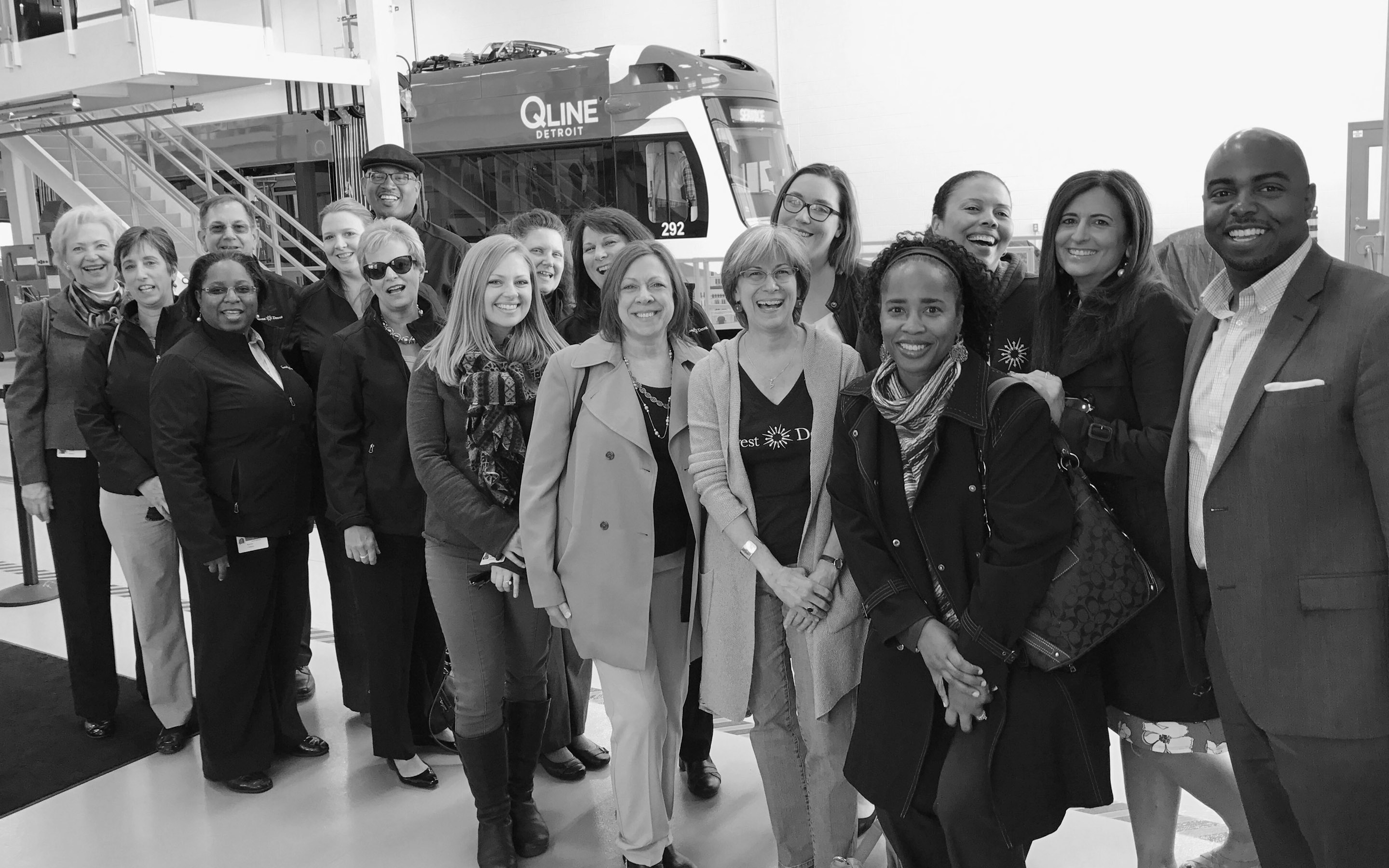 People smiling at the camera, posing in front of a stairwell